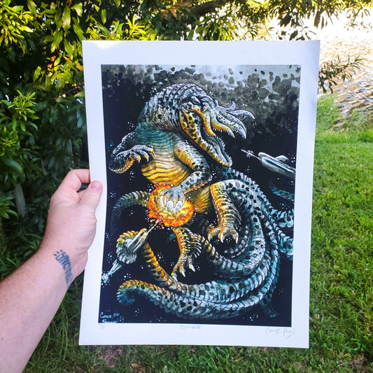 Person holding a print of a detailed dragon illustration outdoors.